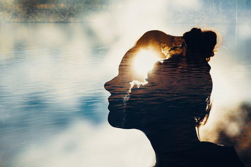 Woman with sun in mind, in nature